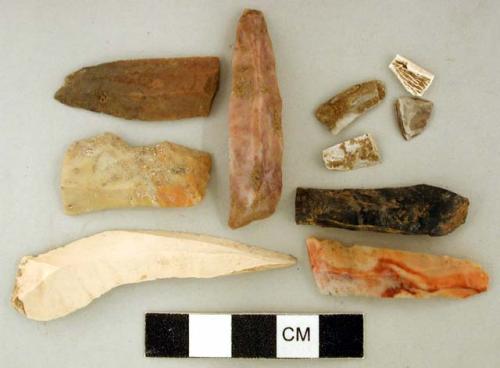 Chipped stone, prismatic blades and flakes, one blade retouched; shell fragments; calcined bone fragment