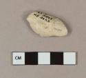 Unsmoked pipe bowl fragment with unidentifiable molded cartouche