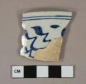 Blue on white handpainted tin-glazed earthenware vessel rim fragment, buff paste