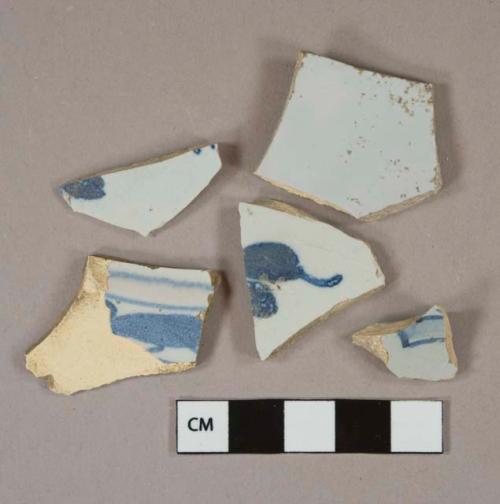 Blue on white handpainted tin-glazed earthenware vessel body and base fragments, buff paste