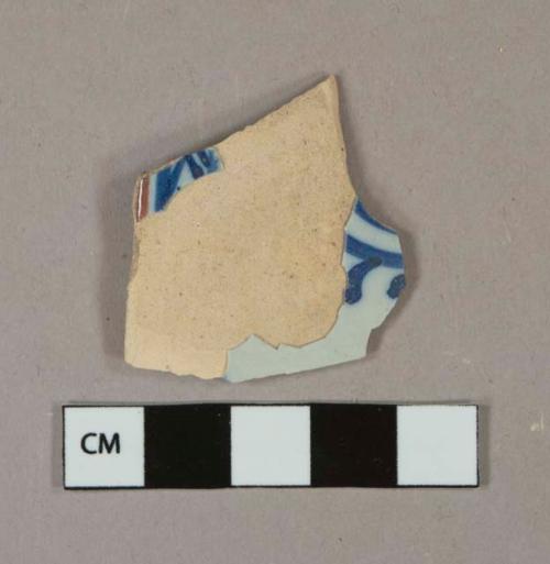 Blue and brown on white handpainted tin-glazed earthenware vessel body fragment, buff paste