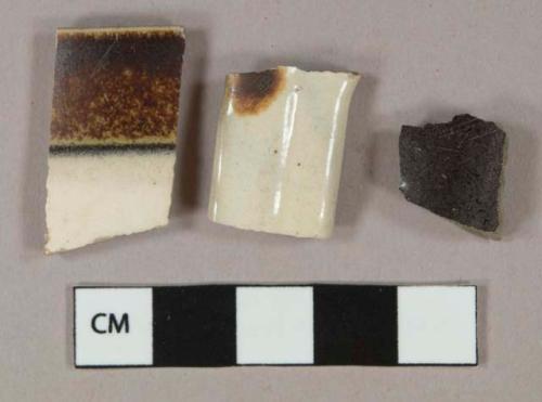 Cream and dark brown salt-glazed stoneware vessel body, rim, and handle fragments, grayish buff paste