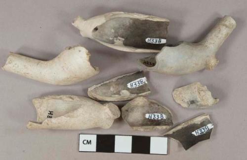 White kaolin pipe bowl fragments, 1 bowl with indeterminate stamp, 1 bowl with rouletting and indeterminate stamp on foot