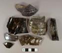 Dark brown opaque lead glazed earthenware vessel body, rim, and base fragments