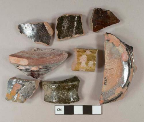 Brown lead glazed earthenware vessel body, base, rim, and handle fragments, red paste, 2 fragments with gray paste, molded bands around base