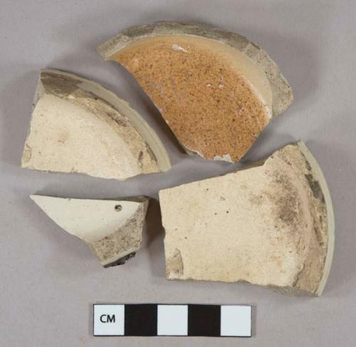Cream-colored salt glazed stoneware vessel base fragments, buff paste