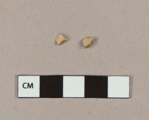 Tin glaze earthenware body sherds, missing all glaze; two sherds crossmend