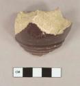 Molded, purple-tinted tin glaze earthenware body sherds; two sherds crossmend