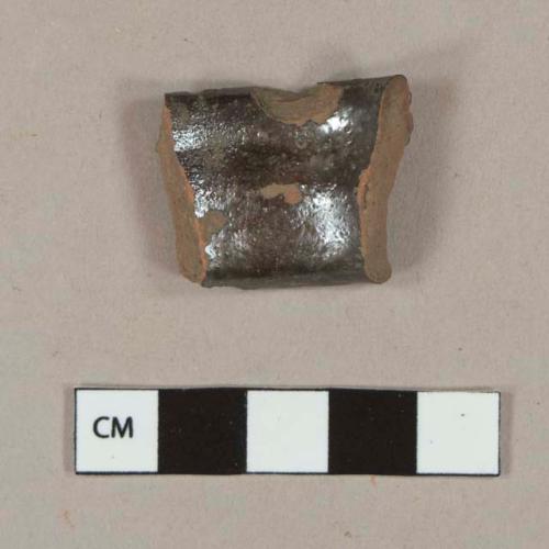 Undecorated lead glazed redware handle sherd