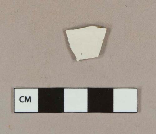 Whiteware body sherd with unidentifiable fragment of blue decoration