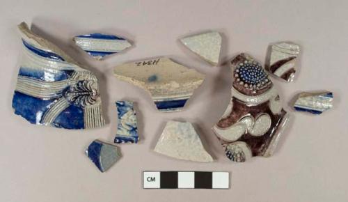 Gray salt glazed stoneware vessel body, base, and rim fragments, cobalt and manganese decorated, molded decorations, gray paste, Westerwald type