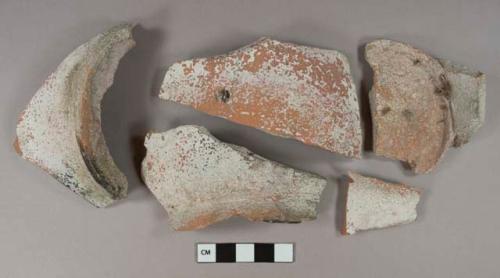 Unglazed redware vessel body and base fragments, all mend