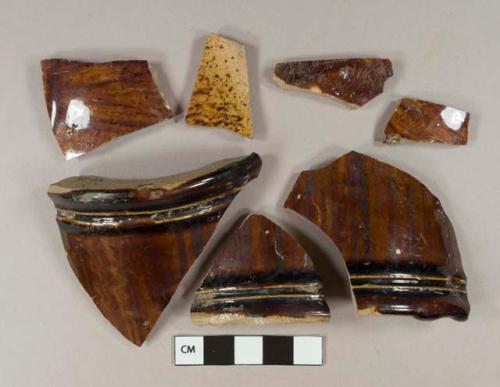 Brown mottled lead glazed earthenware vessel body and base fragments, buff paste, likely Rockingham type