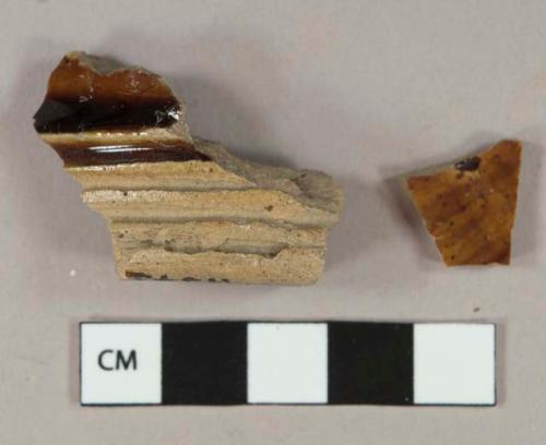 Mottled brown lead glazed earthenware vessel base and body fragments, buff paste, likely Rockingham type