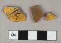 Yellow slip glazed earthenware vessel body fragments, scratch decoration, gray paste, possible North Devon sgraffito