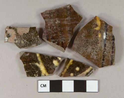 Yellow on Dark brown slip decorated earthenware vessel body and rim fragments, gray and red paste