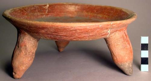 Shallow red polished pottery tripod dish.