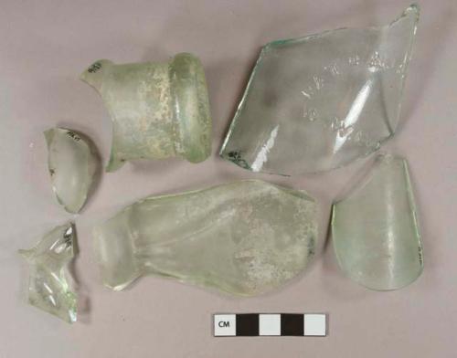Light aqua glass body and finish fragments, 1 fragment with embossed lettering "PATD AUG[...] / W.W. LY[...]," rolled finish