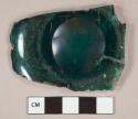 Dark teal green vessel glass fragment, possible base fragment, divot on surface with wear surrounding