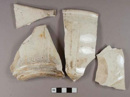 White undecorated ironstone vessel body, base, and rim fragments, molded fluting, possible pour spout on one rim fragment