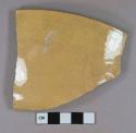 undecorated yellowware vessel rim fragment, buff paste