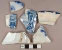White pearlware vessel rim, body, and base fragments, 4 transferprinted fragments, 1 blue shell-edged fragment, white paste