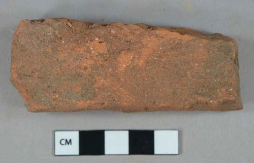 Unglazed, undecorated terracotta tile fragment