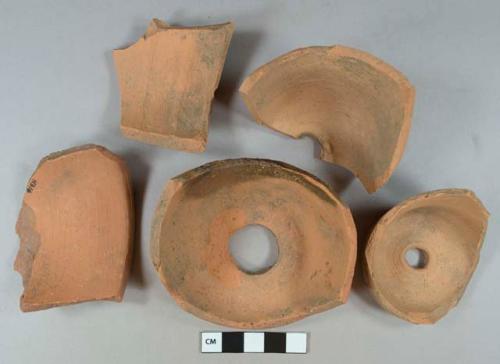 Unglazed terra cotta vessel base, body, and rim fragments, red paste