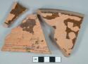 Brown lead glazed redware vessel rim fragments, red paste