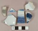 Blue on white handpainted porcelain vessel body, base, and rim fragments, 1 fragment with brown opaque glaze on exterior, white paste