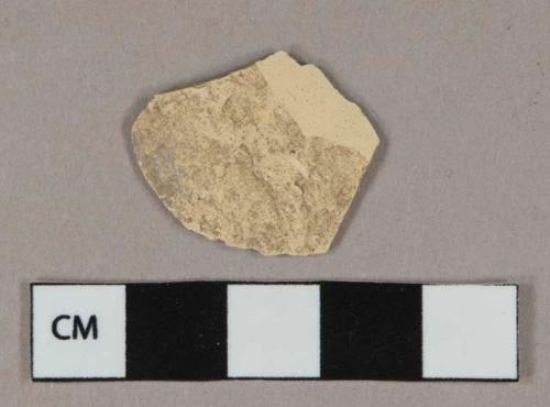 Unglazed earthenware vessel body fragment, buff paste, likely formerly tin-glazed