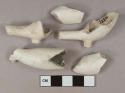 White undecorated kaolin pipe bowl fragments, 1 with "T" and "D" stamped on either side of foot