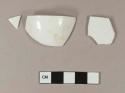 Undecorated porcelain rim sherds; two sherds crossmend