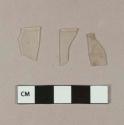 Colorless plastic fragments with rounded rim; two fragments crossmend