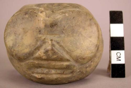 Half of large stone bead with carved face