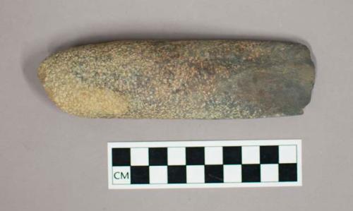Stone adze blade; ground and polished down to a thin edge