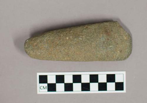 Stone adze blade; ground to a sharp edge