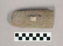 Ground stone tool, broken, possibly end of adze or pestle