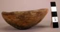 Ceramic bowl, rounded base, flaring sides, straight rim, red/brown slip, worn, b