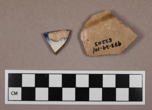 Sherds, one with salt glaze, one rim, with blue markings.