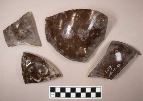 Miscellaneous body sherds from ceramic bean pots. dark brown glaze.