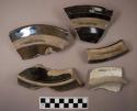 Miscellaneous lid sherds of bean pots. brown and white glaze from flat lids.