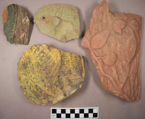 Miscellaneous ceramic body sherds from mold-made pottery. raised designs painte