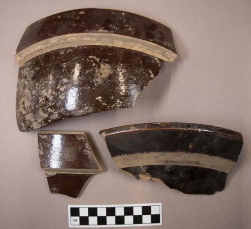 Miscellaneous rim sherds from bowls. brown glaze, bean-pot style.