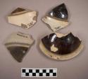 Miscellaneous sherds from either bowls or domed lids. brown and white glaze.