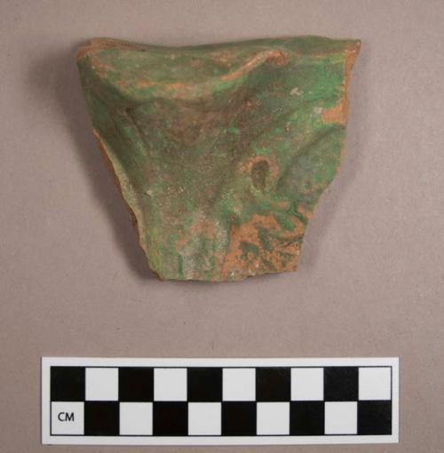 Ceramic base sherd with mold made design; Painted green