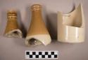 Sherds from earthenware bottles. two necks and one base. two-toned beige-brown g