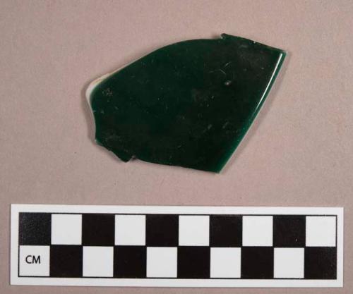 Sherd from a glass bowl. formed of two layers--green and white.