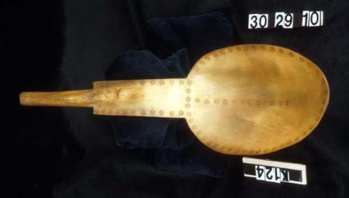 Spoon made of mountain sheep horn decorated with circle dots.