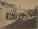 People loading goods onto donkeys